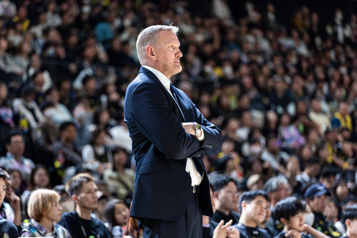 腕を組み真剣な表情のコーチ