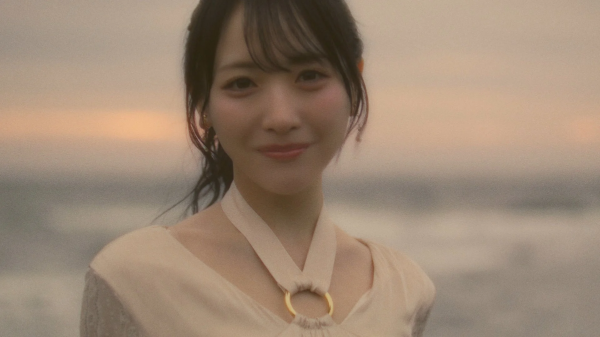 夕暮れの海辺で穏やかな笑顔を見せる石田千穂さん